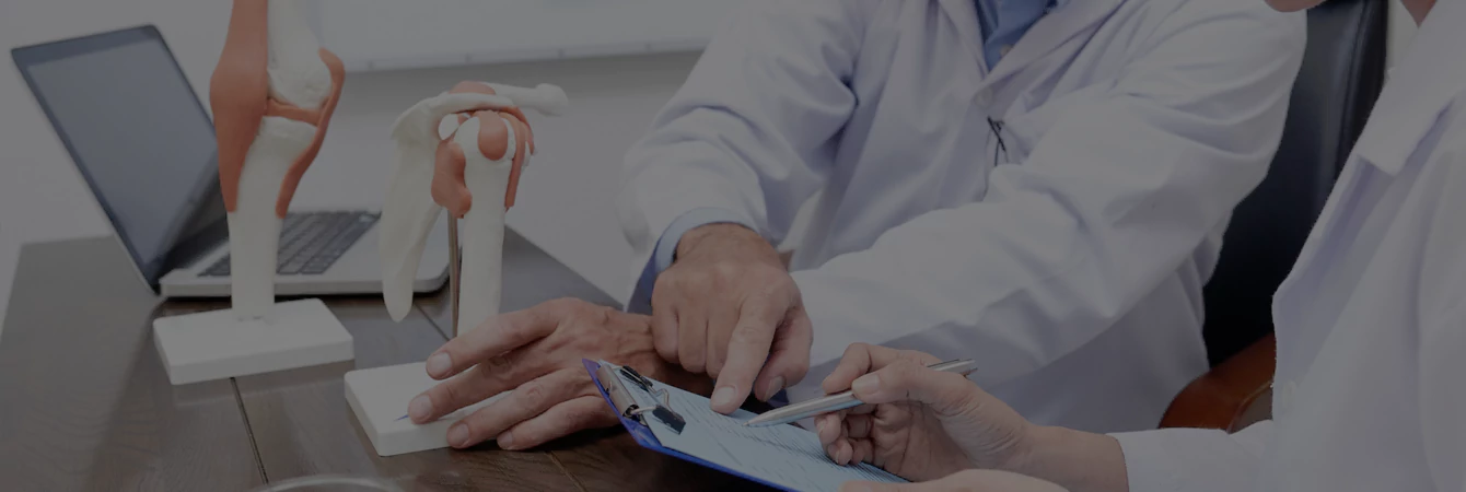 A doctor consults a patient about their pain treatment